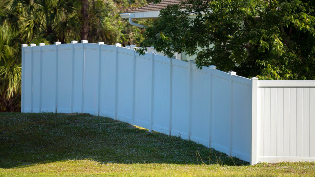 beautiful vinyl fence by dubon fencing and polish concrete basking in sunlight