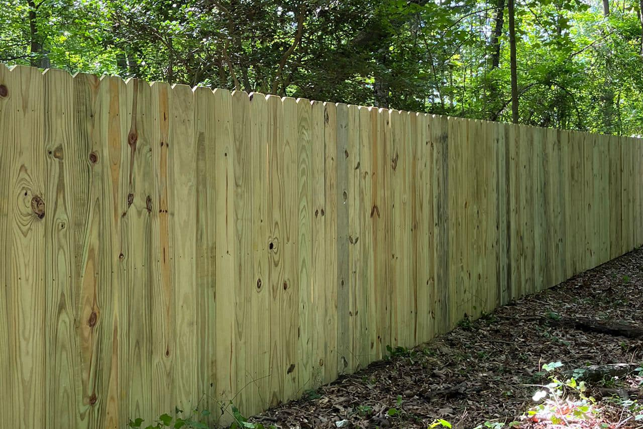 wood fence near the forest by dubon fencing llc