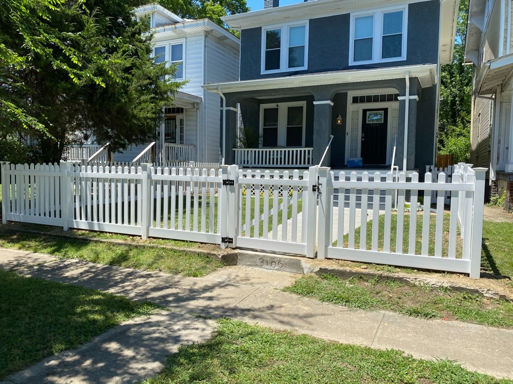 White vinyl picket fence with gate in front of a Richmond home.