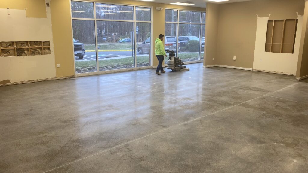 Glossy polished concrete floor reflecting overhead lights in Henrico.
