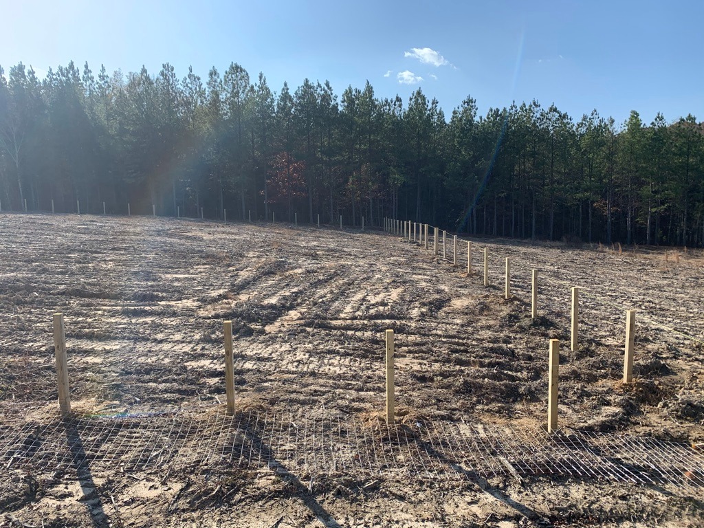 Chainlink posts installed for a large rural property boundary in Dinwiddie, VA.